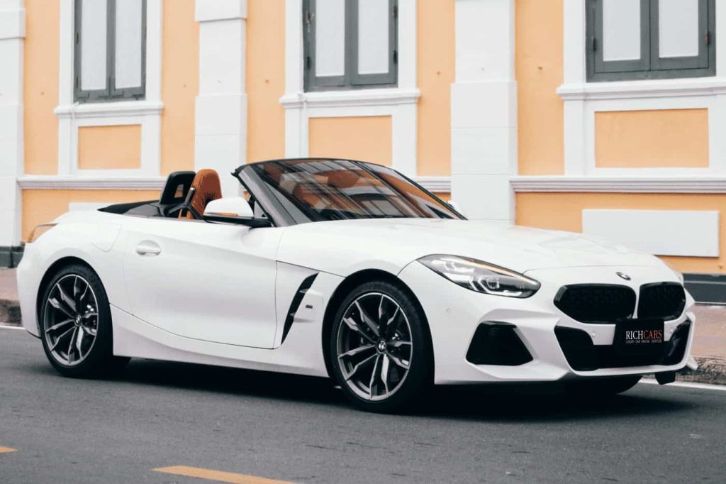 Starting at 19,000 Baht/1 Day

**BMW Z4 M40i Sport: A Symphony of Performance and Style**

Embark on an exhilarating journey with the BMW Z4 M40i Sport, a convertible that seamlessly blends power and sophistication. Powered by a robust 3.0-liter 6-cylinder turbocharged gasoline engine, the Z4 M40i delivers an impressive 382 horsepower and 500 Newton-meters of torque.

*Performance:*
- **Engine:** 3.0L 6-cylinder turbocharged gasoline engine.
- **Power Output:** 382 hp, 500 Nm torque.
- **Top Speed:** 250 km/h.
- **Acceleration:** 0 to 100 km/h in 4.1 seconds.
- **Fuel Efficiency:** 11.2 km/l.

*Distinctive Features:*
- M Sport Styling Enhancements
- Adaptive M Suspension
- Electrically Retractable Soft Top
- M Sport Brakes
- 8-Speed Automatic Transmission

*Luxurious Interior:*
- Vernasca Leather Seats
- Electrically Adjustable M Sport Seats
- Advanced Infotainment System
- Harman Kardon Surround Sound System

*Driving Dynamics:*
- Rear-Wheel Drive
- 8-Speed Automatic Transmission
- Launch Control

*Price:*
Starting at 3,899,000 Baht, the BMW Z4 M40i Sport offers an exceptional combination of performance, style, and cutting-edge technology, making it a standout choice for those seeking the ultimate convertible experience.