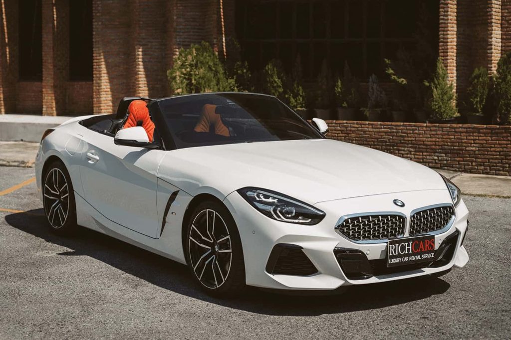 Starting at 15,000 Baht/1 Day

**BMW Z4 sDrive30i: Dynamic Roadster Experience**

The BMW Z4 sDrive30i offers a dynamic driving experience with a 2.0-liter 4-cylinder engine, delivering 255 horsepower and 400 Newton-meters of torque. Accelerating effortlessly, it reaches a top speed of 250 km/h, all while maintaining an impressive fuel efficiency of 14.7 km/l.

**Z4 sDrive30i Features:**

- **Open-Top Driving:** Experience the joy of open-top driving with the Z4 sDrive30i's retractable roof, perfect for enjoying the open road and the wind in your hair.
- **Rear-Wheel Drive:** Enjoy precise handling and responsiveness with the rear-wheel-drive configuration and an 8-speed automatic transmission.
- **Sporty Exterior Design:** The Z4 sDrive30i features a sporty exterior design, accentuated by sleek lines, an iconic kidney grille, and distinctive LED headlights.
- **Comfortable Interior:** Indulge in luxury with premium materials, comfortable seating, and modern features, creating an inviting and enjoyable cockpit.
- **Cutting-Edge Technology:** Stay connected and entertained with advanced technology, including a user-friendly infotainment system, navigation, and smartphone integration.
- **Harman Kardon Sound System:** Elevate your driving experience with the premium Harman Kardon audio system, delivering high-quality sound through its impressive speaker setup.

**Price and Availability:**

The BMW Z4 sDrive30i is available at a starting price of 3,499,000 Baht, offering a perfect blend of performance, style, and cutting-edge technology for enthusiasts seeking a dynamic roadster.