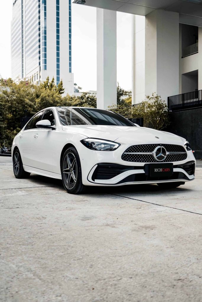 Starting at 9,900 Baht/1 Day

**Engine Options:**

The Mercedes-Benz C350e AMG 2023 is a premium sedan featuring a plug-in hybrid system. It is equipped with a 2.0-liter 4-cylinder gasoline engine, turbocharged, providing a maximum power of 255 horsepower. Additionally, an electric motor contributes an extra 132 horsepower, resulting in a combined maximum power of 387 horsepower and a robust peak torque of 500 Newton-meters. This hybrid marvel can achieve a top speed of 250 kilometers per hour, and its fuel consumption averages an impressive 45.5 kilometers per liter.

**C350e AMG 2023 Features:**

- **Drive System:** All-wheel drive with a 9-speed automatic transmission.
- **AMG Line Styling:** The C350e boasts both exterior and interior AMG Line enhancements, exuding a sporty and sophisticated aura.
- **Interior Luxury:** The interior is adorned with genuine leather seats, electrically adjustable front seats, driver's seat memory function, and a Head-Up Display for driving information.
- **Automated Features:** Adaptive cruise control, electrically adjustable steering wheel, and a 4-zone automatic air conditioning system contribute to a luxurious and convenient driving experience.
- **Entertainment System:** The Burmester 3D Surround Sound System adds an immersive audio experience to the interior.

**Price and Availability:**

The Mercedes-Benz C350e AMG 2023 is available with a starting price of 3,990,000 Baht. It represents a vehicle that combines excellent performance, fuel efficiency, and cutting-edge technology, making it a compelling choice for those seeking a premium sedan in Thailand.